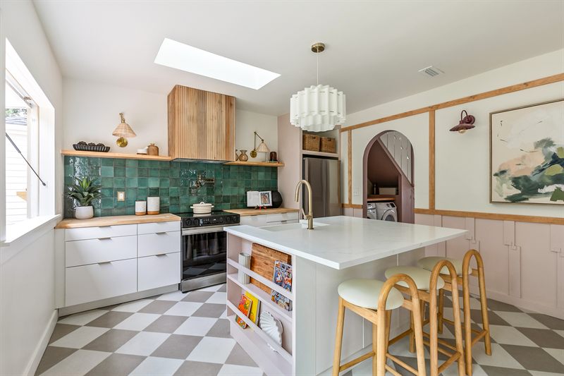 Kitchen with green zellige tile, butcher-block counters, a checkerboard floor and a white island